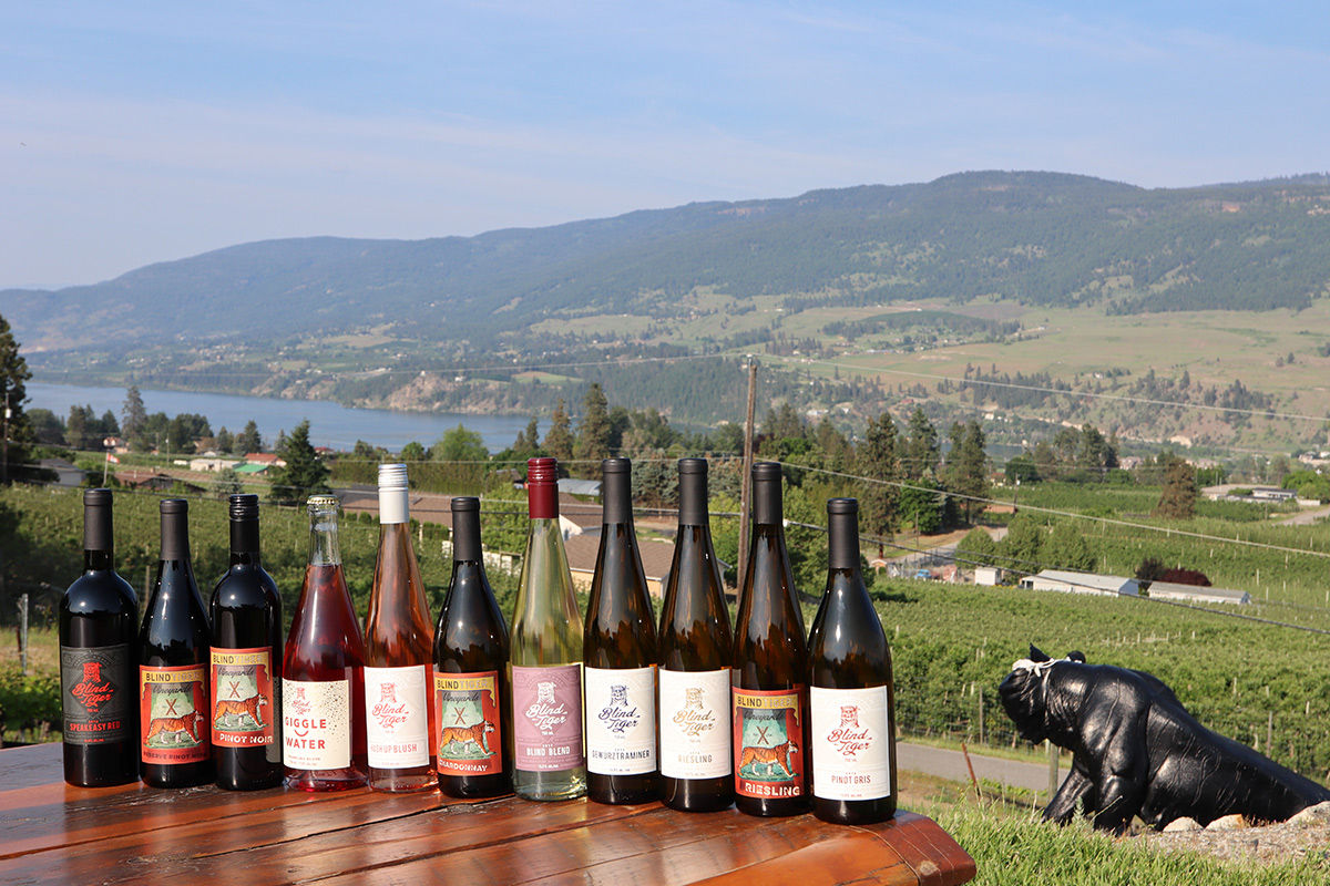 Enjoy a refreshing sip with views of Wood Lake. Photo courtesy of Blind Tiger Winery.
